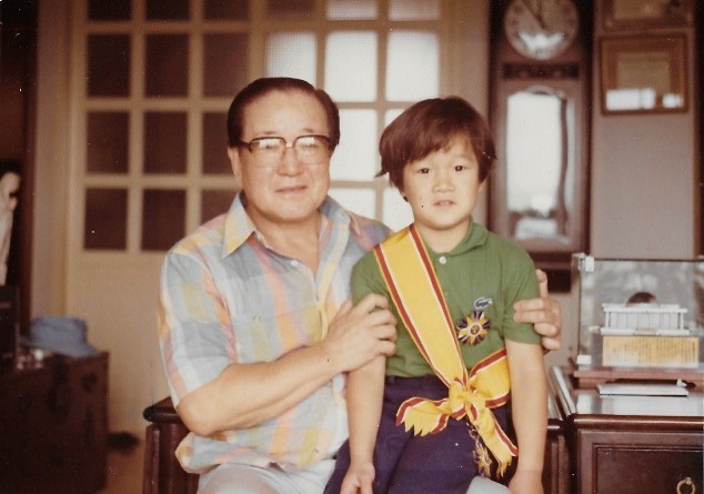 A childhood photo of Patrick with his grandfather.